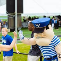 Louie the Laker giving a guest a high-five at the Jamie Hosford Football Center dedication.